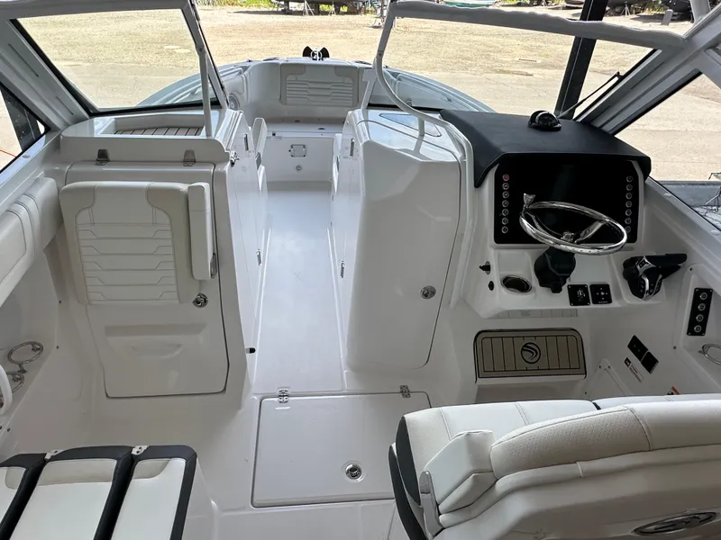 Slide: The Image of 2026 Edgewater 262CX Crossover boat interior with modern helm and seating. - 20