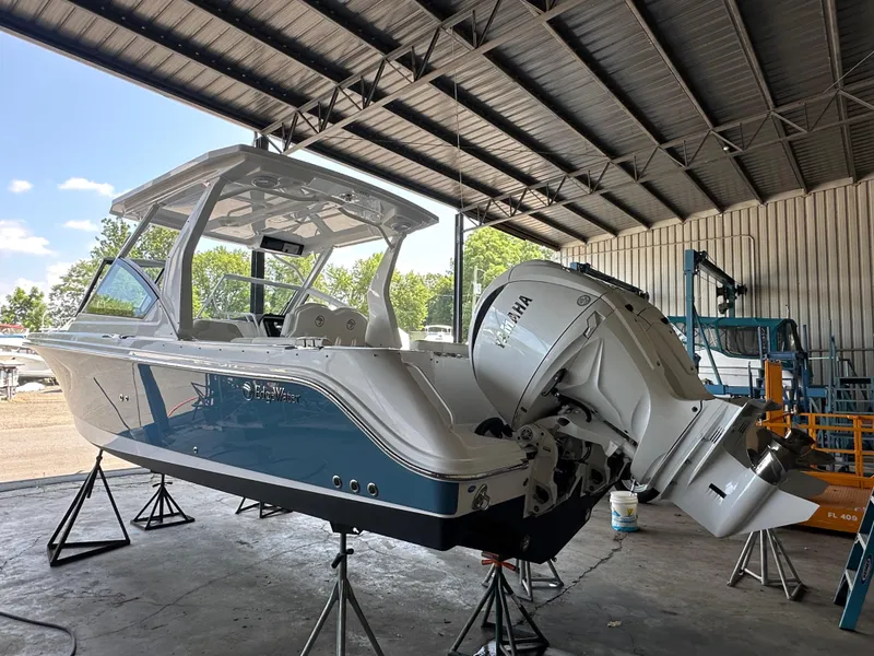 Slide: The Image of 2026 Edgewater 262CX Crossover boat in a covered marina, featuring a Yamaha outboard motor. - 4