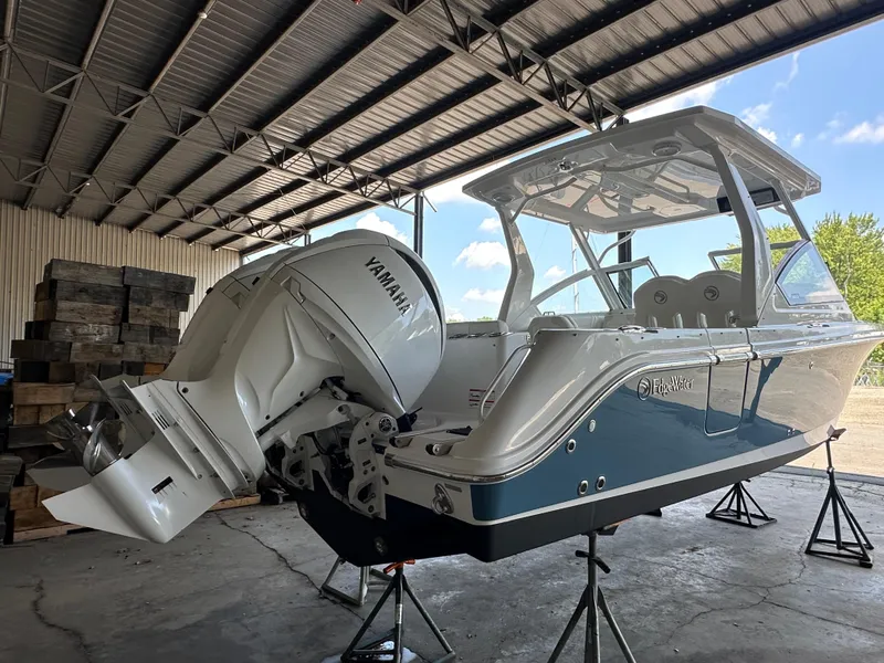 Slide: The Image of 2026 Edgewater 262CX Crossover boat with Yamaha engine in a covered storage area. - 6