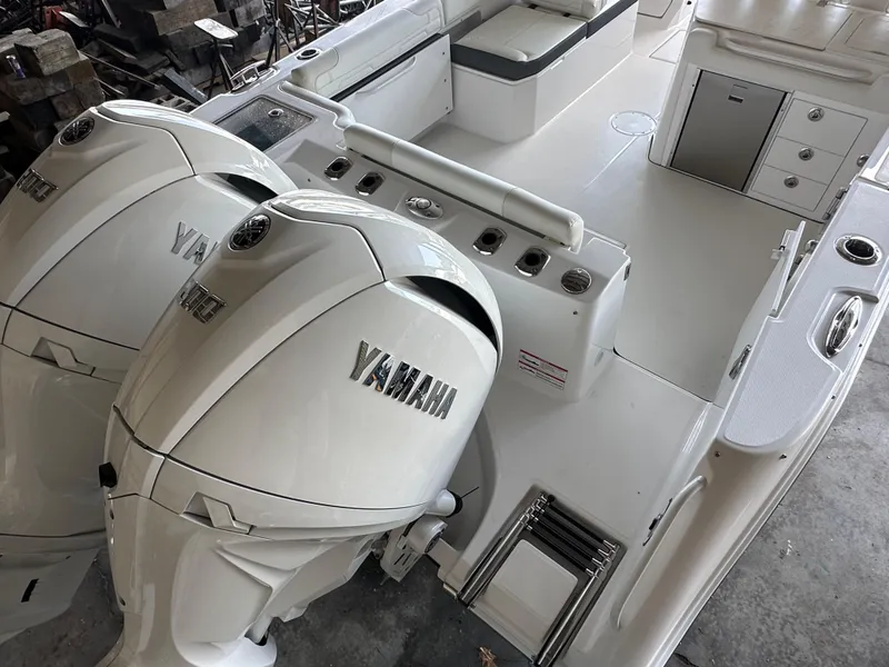 Slide: The Image of 2026 Edgewater 262CX Crossover boat with dual Yamaha outboard engines, spacious deck layout. - 7