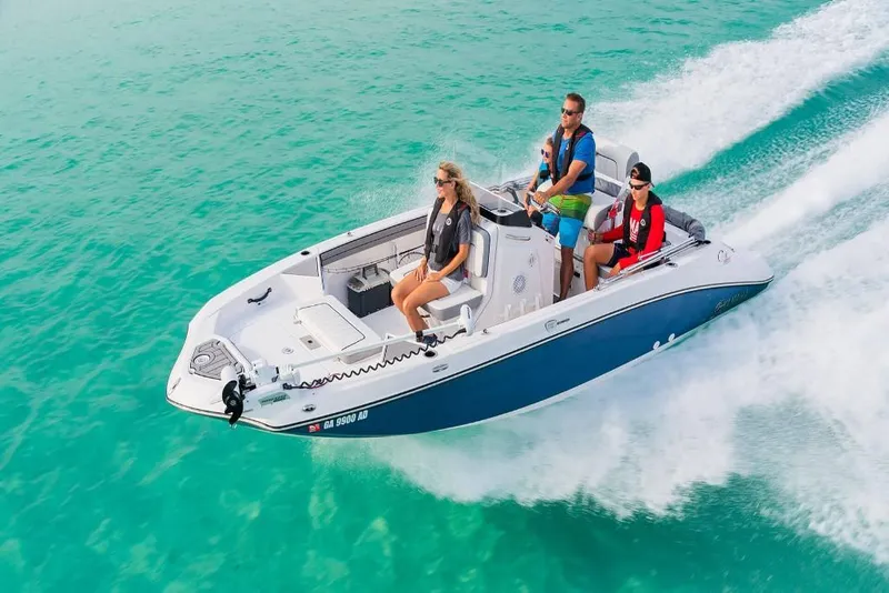 Slide: The Image of 2023 Yamaha Boats 190 FSH Deluxe cruising on clear turquoise water. - 0