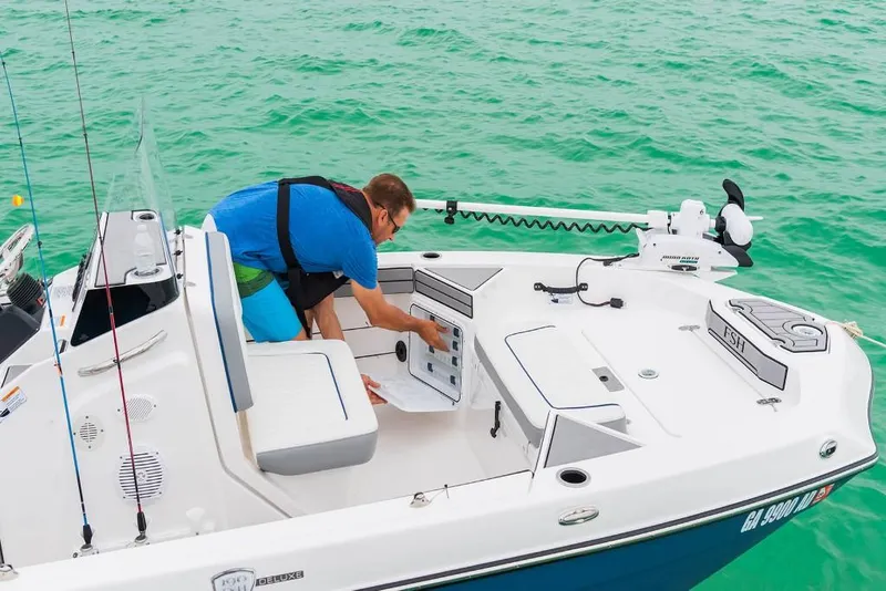 Slide: The Image of Man on 2023 Yamaha Boats 190 FSH Deluxe fishing boat in clear water. - 1