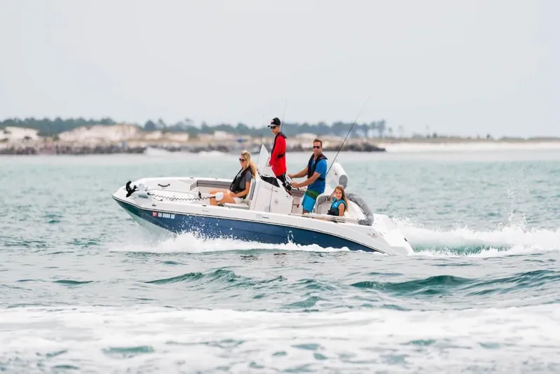 Slide: The Image of 2023 Yamaha Boats 190 FSH Deluxe cruising on the water with passengers. - 4