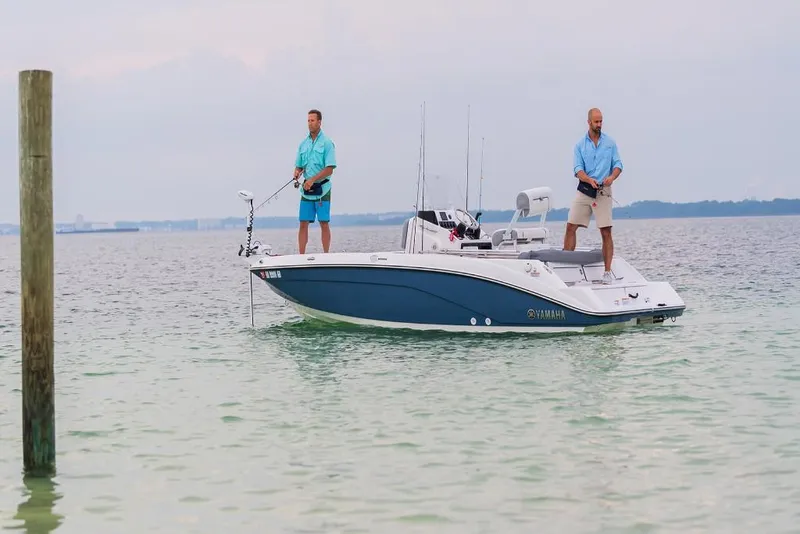 Slide: The Image of 2023 Yamaha Boats 190 FSH Deluxe fishing on calm waters. - 6