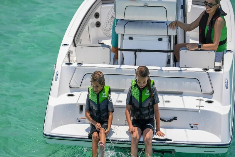 Slide: The Image of 2023 Yamaha Boats 190 FSH Sport with kids and adult enjoying on the water. - 11