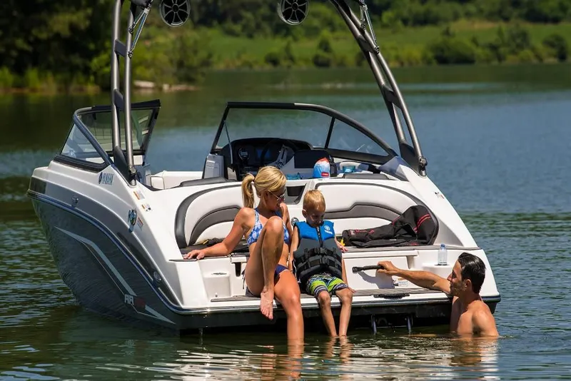 Slide: The Image of 2023 Yamaha Boats AR195 with family enjoying water activities. - 3