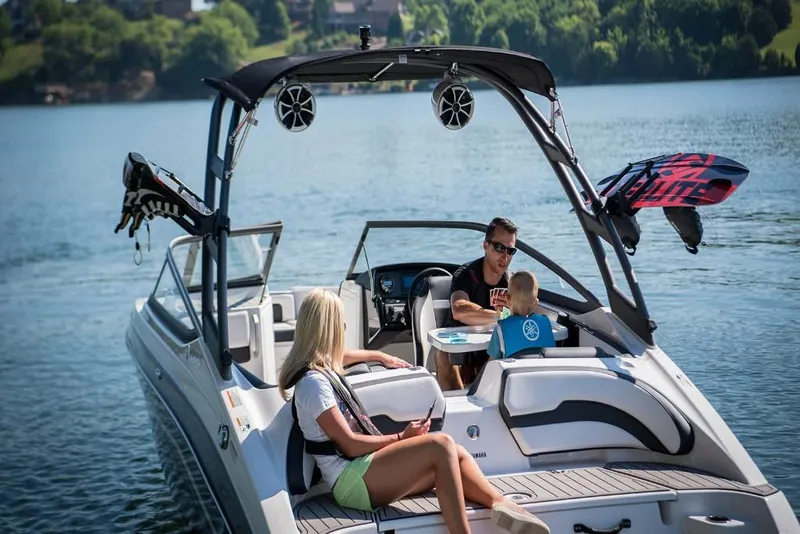 Slide: The Image of 2023 Yamaha Boats AR195 on a lake with family enjoying leisure time. - 4