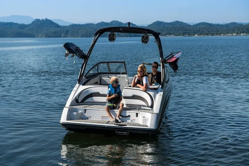 Slide: The Image of 2023 Yamaha Boats AR195 on a serene lake with passengers enjoying the view. - 5