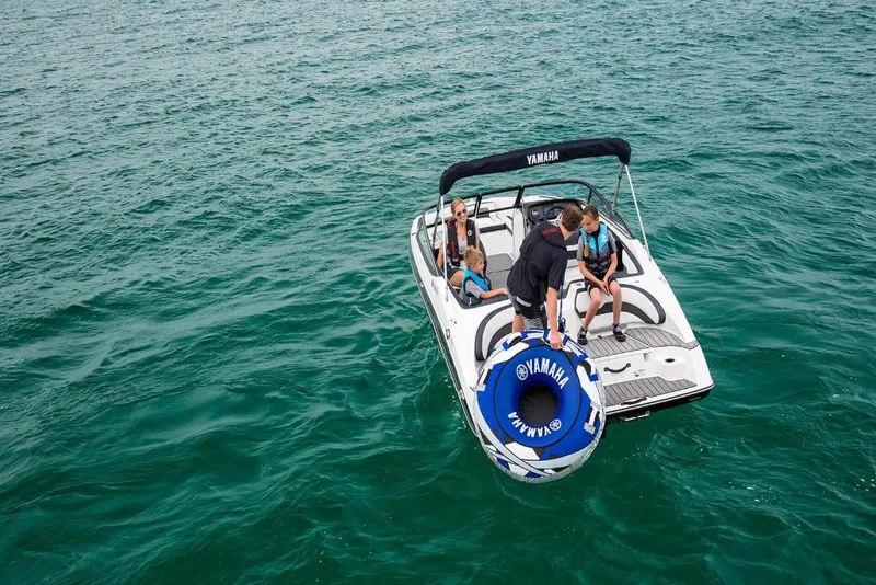 Slide: The Image of 2023 Yamaha SX195 boat with people enjoying water activities. - 3