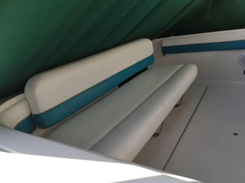 Slide: The Image of 1993 Tiara Yachts 270 Sport Cruiser interior seating area with white and teal upholstery. - 10
