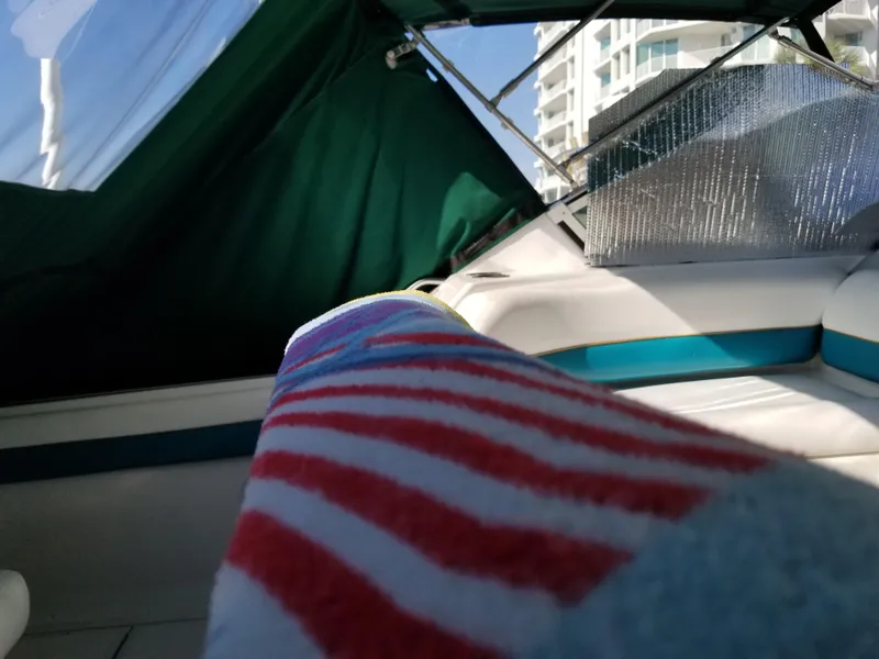 Slide: The Image of Interior of a 1993 Tiara Yachts 270 Sport Cruiser with striped towel and green canopy. - 12