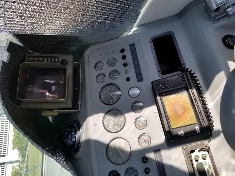 Slide: The Image of 1993 Tiara Yachts 270 Sport Cruiser dashboard with gauges and navigation equipment. - 14