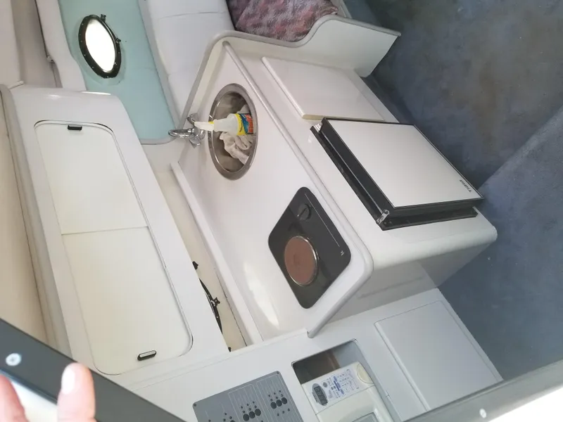 Slide: The Image of 1993 Tiara Yachts 270 Sport Cruiser interior kitchen with sink, stove, and mini-fridge. - 16
