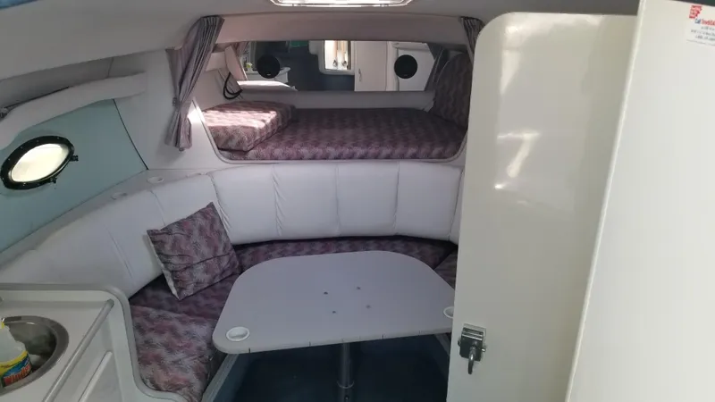 Slide: The Image of Interior of 1993 Tiara Yachts 270 Sport Cruiser with seating and sleeping area. - 17
