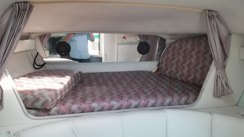 Slide: The Image of 1993 Tiara Yachts 270 Sport Cruiser cabin interior with bed and curtains. - 19