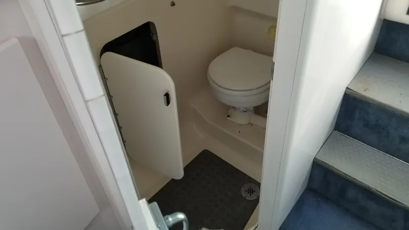 Slide: The Image of 1993 Tiara Yachts 270 Sport Cruiser bathroom with toilet and storage. - 20