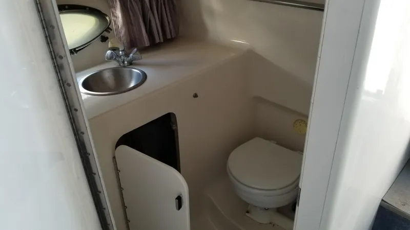 Slide: The Image of 1993 Tiara Yachts 270 Sport Cruiser bathroom with sink and toilet. - 21