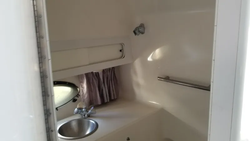 Slide: The Image of 1993 Tiara Yachts 270 Sport Cruiser bathroom with sink and porthole window. - 22