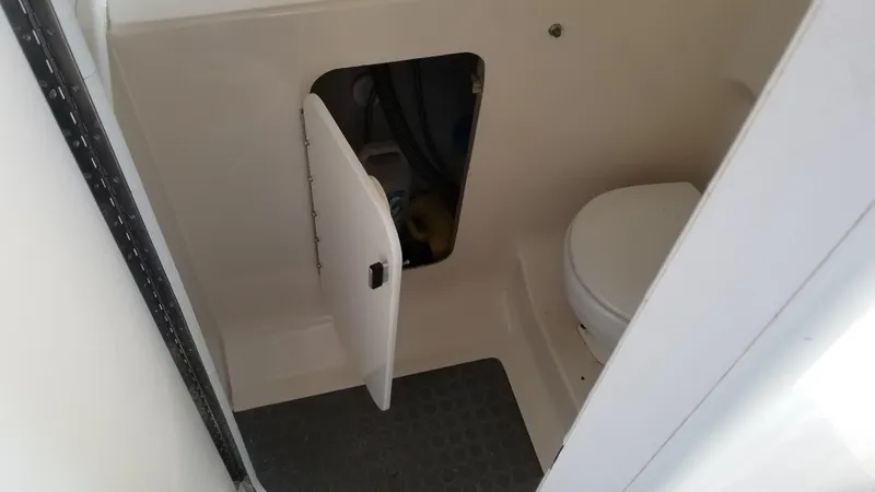 Slide: The Image of 1993 Tiara Yachts 270 Sport Cruiser bathroom with storage compartment and toilet. - 24