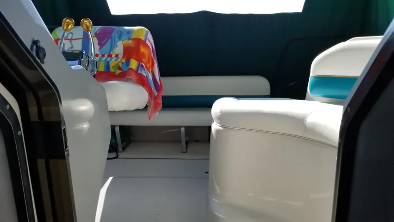 Slide: The Image of 1993 Tiara Yachts 270 Sport Cruiser interior with seating and colorful towel. - 26