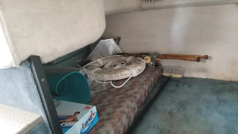 Slide: The Image of Interior of 1993 Tiara Yachts 270 Sport Cruiser with fishing gear and life ring. - 33