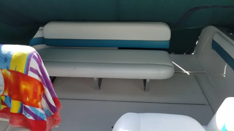 Slide: The Image of 1993 Tiara Yachts 270 Sport Cruiser interior seating area with colorful towel. - 36