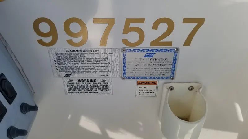 Slide: The Image of 1993 Tiara Yachts 270 Sport Cruiser with registration number 997527 and safety warnings. - 37