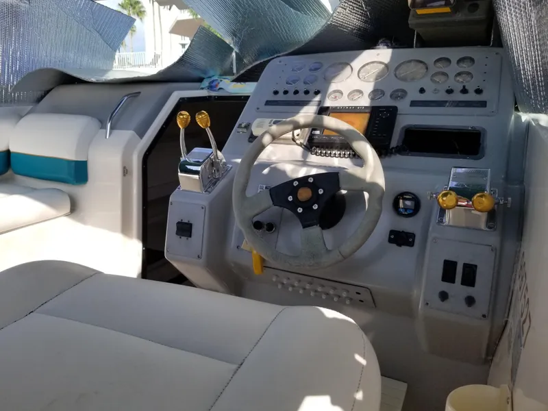 Slide: The Image of 1993 Tiara Yachts 270 Sport Cruiser helm with steering wheel and control panel. - 4