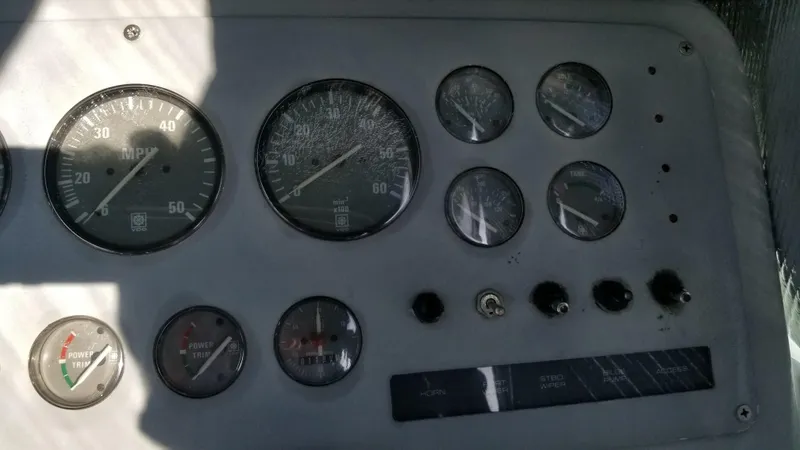 Slide: The Image of Dashboard of a 1993 Tiara Yachts 270 Sport Cruiser with various gauges and controls. - 41