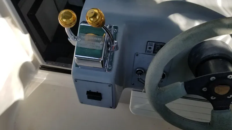 Slide: The Image of 1993 Tiara Yachts 270 Sport Cruiser helm controls and steering wheel. - 43