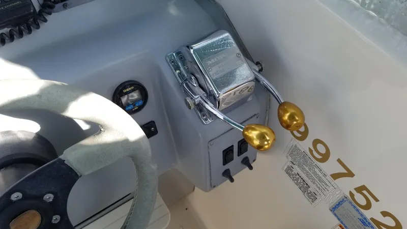 Slide: The Image of 1993 Tiara Yachts 270 Sport Cruiser helm controls and steering wheel. - 44