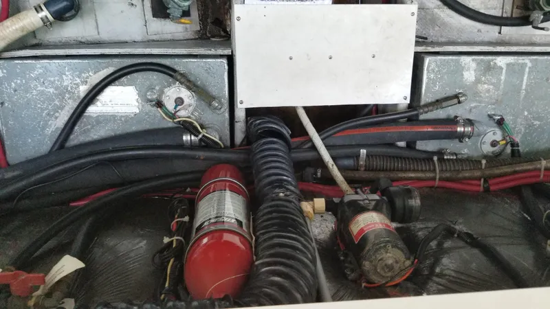 Slide: The Image of Engine compartment of a 1993 Tiara Yachts 270 Sport Cruiser with fire extinguisher and hoses. - 49
