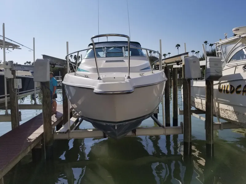 Slide: The Image of 1993 Tiara Yachts 270 Sport Cruiser docked on a boat lift. - 5