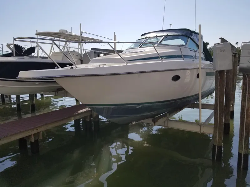 Slide: The Image of 1993 Tiara Yachts 270 Sport Cruiser on a boat lift. - 6