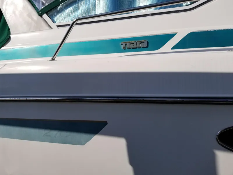 Slide: The Image of 1993 Tiara Yachts 270 Sport Cruiser side view with teal accents. - 7