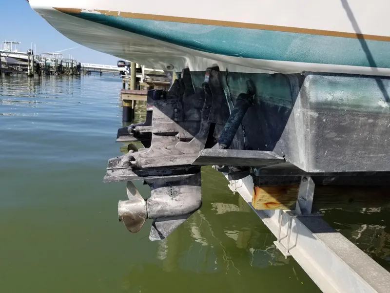 Slide: The Image of 1993 Tiara Yachts 270 Sport Cruiser on a boat lift, showing propellers and stern. - 8