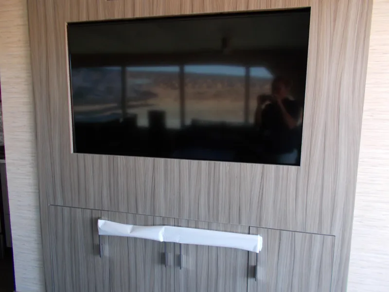 Slide: The Image of Flat-screen TV in Adonia Titan Trip 9, 2016 model, with wood paneling. - 11