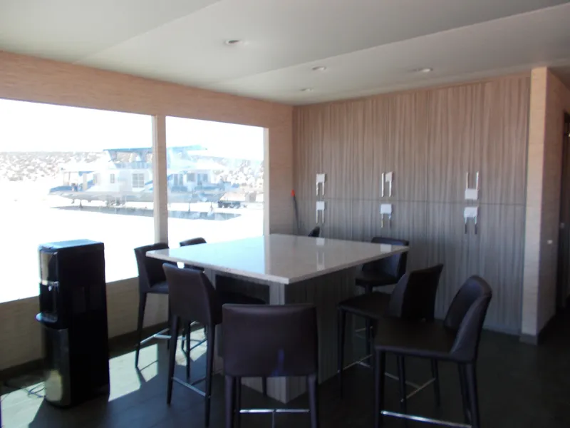 Slide: The Image of Modern interior of 2016 Adonia Titan Trip 9, featuring sleek dining area with large windows. - 13