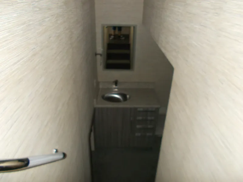 Slide: The Image of Narrow bathroom in 2016 Adonia Titan Trip 9, featuring sink and mirror. - 16