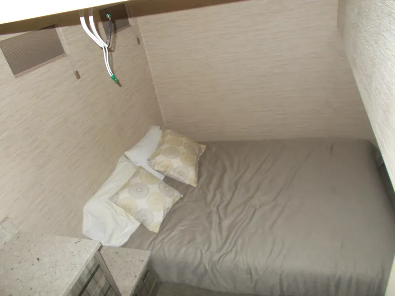 Slide: The Image of Compact bedroom in 2016 Adonia Titan Trip 9, featuring a cozy bed and modern decor. - 17