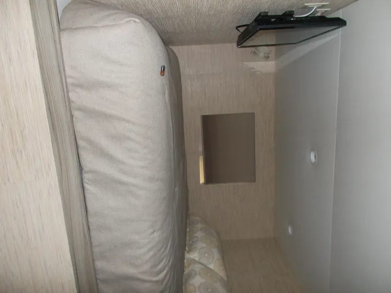 Slide: The Image of Interior of 2016 Adonia Titan Trip 9, featuring a compact sleeping area. - 18