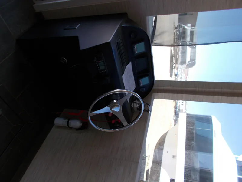 Slide: The Image of Interior helm of 2016 Adonia Titan Trip 9 yacht, featuring steering wheel and control panel. - 26