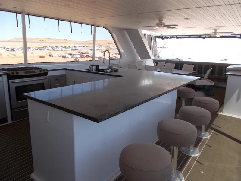 Slide: The Image of Luxurious 2016 Adonia Titan Trip 9 yacht kitchen with bar seating and modern appliances. - 41