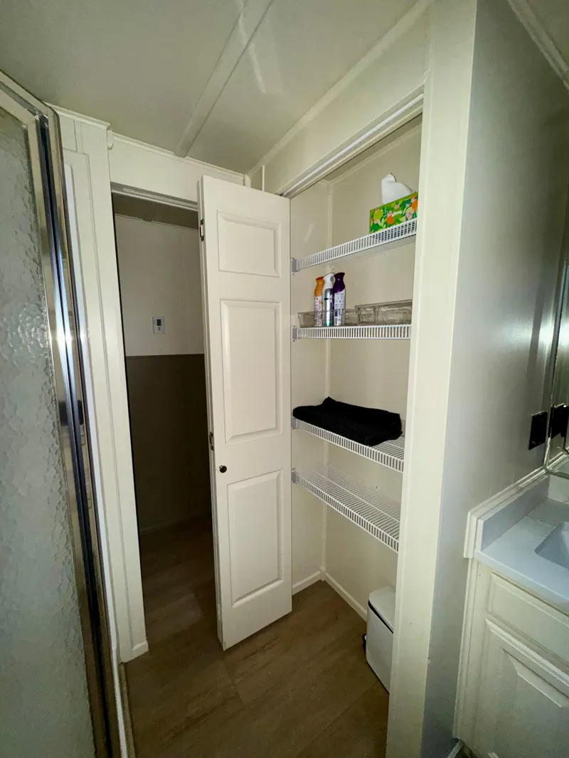 Slide: The Image of Bathroom storage in 2008 Sumerset Waterways Houseboat, featuring shelves and shower. - 13