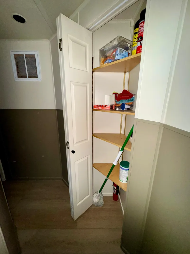 Slide: The Image of Small storage closet in 2008 Sumerset Waterways houseboat with cleaning supplies and shelves. - 15