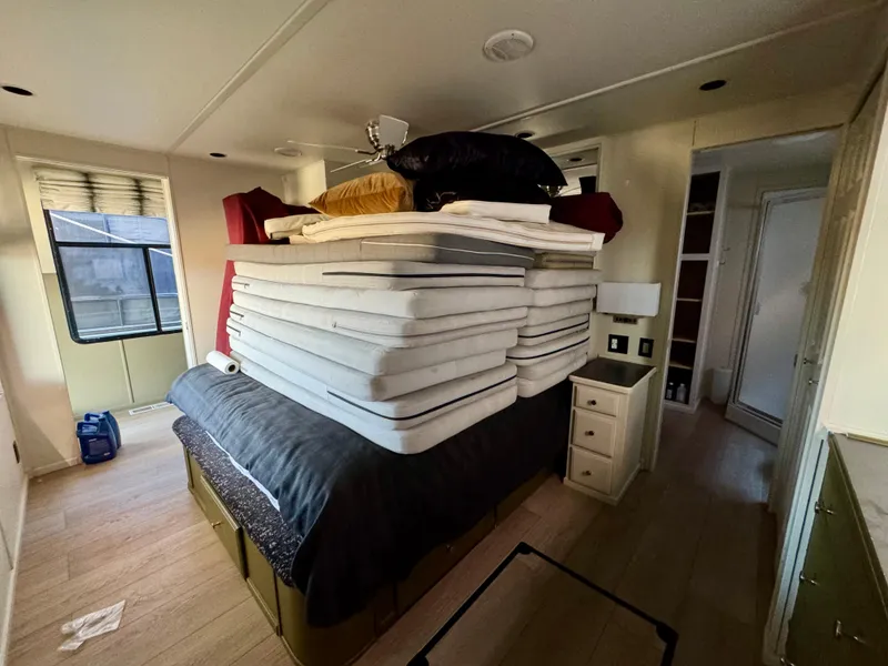 Slide: The Image of A 2008 Sumerset Waterways houseboat bedroom with stacked mattresses and modern decor. - 18