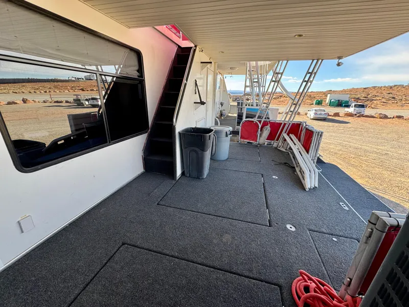 Slide: The Image of 2008 Sumerset Waterways Houseboat deck with stairs, outdoor seating, and scenic view. - 21