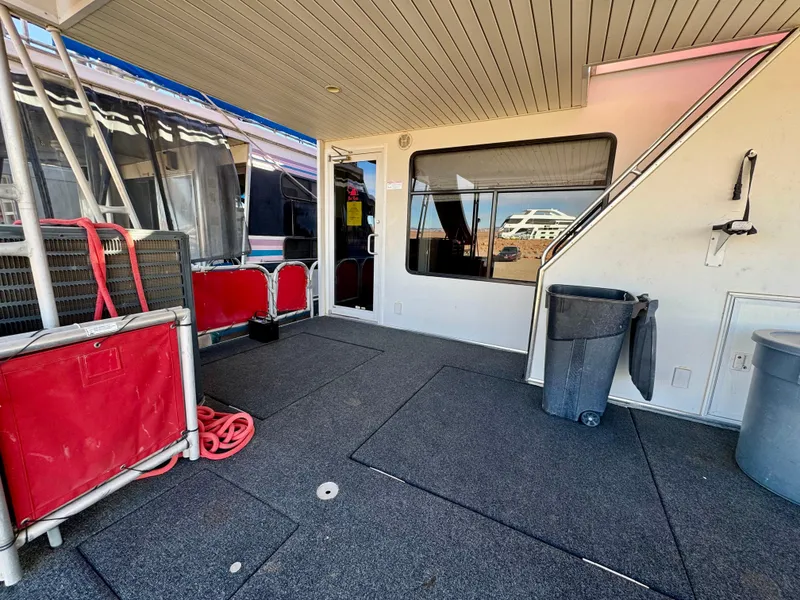 Slide: The Image of 2008 Sumerset Waterways houseboat deck with red accents and outdoor seating. - 22