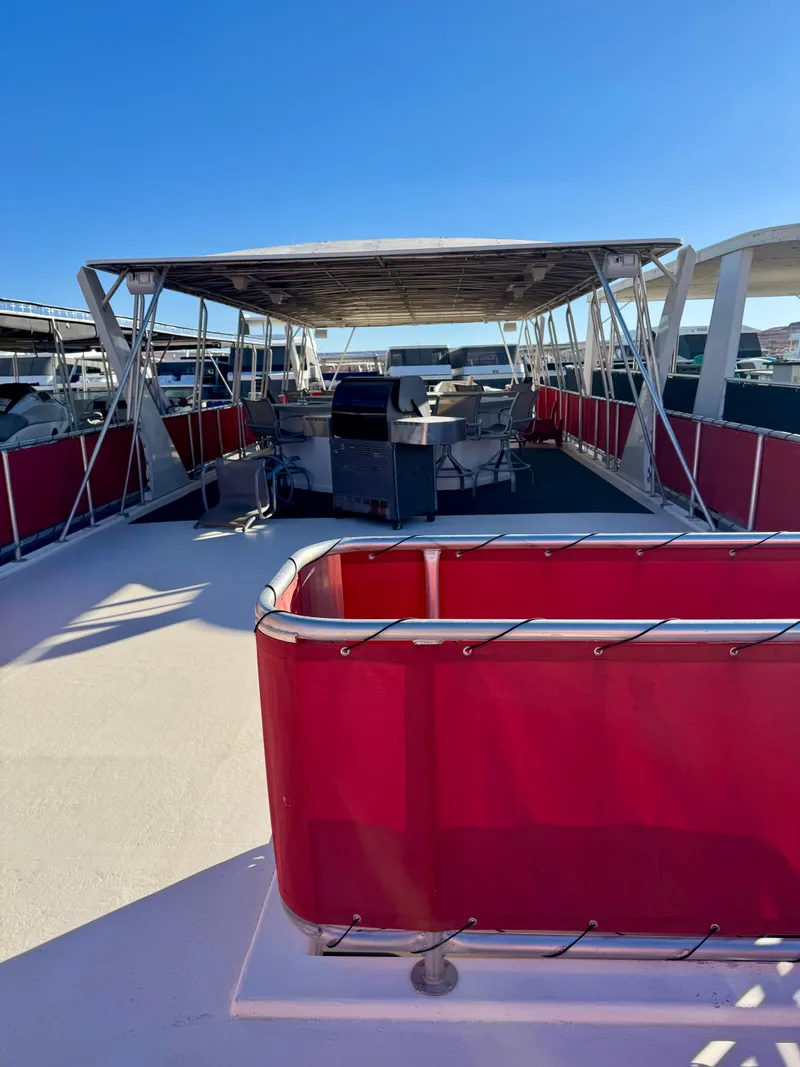 Slide: The Image of 2008 Sumerset Waterways Houseboat with red railing and covered deck area. - 23