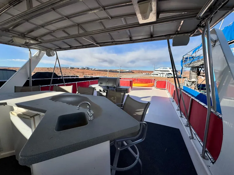 Slide: The Image of 2008 Sumerset Waterways Houseboat deck with seating, sink, and scenic view. - 24